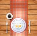 Heart-shaped fried eggs on white plate and coffee cup Royalty Free Stock Photo