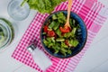 top view of vegetable salad and salt on plaid cloth with detox water and lettuce on wooden background