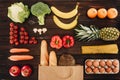 Top view of vegetables and fruits, bread and eggs on wooden table Royalty Free Stock Photo