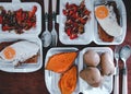 Top view of vegetarian lunchboxes - omelet, fresh vegetable salad, baked pumpkin and potatoes