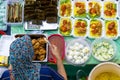 Top view of vendor preparing Yellow Rice package at the food stall in Kota Kinabalu city food market