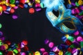 Top view of venetian masquerade mask and colorfull confetti. Royalty Free Stock Photo