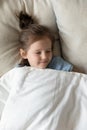 Top view cute peaceful little girl sleeping in cozy bed