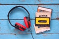 Top view of vintage headphones and cassettes over aqua wooden table. retro filtered