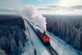 Top view of vintage holiday train traveling through a snowy landscape among forests and mountains