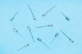 top view of vintage hypodermic needles on blue