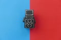 Top view of a vintage toy camera on a two color background which are blue and red Royalty Free Stock Photo