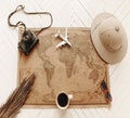 Top view of vintage world map with objects related to journey, excursions and tours Royalty Free Stock Photo