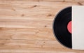 Top view of vinyl record over wooden table.