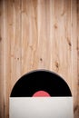 Top view of vinyl record over wooden table.