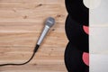 Top view of vinyl record over wooden table and microphone