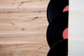 Top view of vinyl records over wooden table.