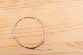 Top view of a violin string on a wooden background.