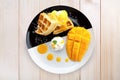 Top view waffle with ice cream and mango on wood table