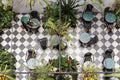 Top view of waiter cleaning table in Cozy outdoor cafe with plant.