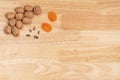 Top view of walnuts, dried apricots and pine nuts with copyspace on a wooden table Royalty Free Stock Photo