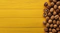 Top view of walnuts on yellow rustic background