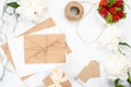 Top view wedding feminine accessories on marble background. Minimal flat lay style composition with strawberry, craft paper