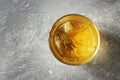 Top view of whiskey with ice in a glass on a gray concrete background, close-up. Overhead Royalty Free Stock Photo