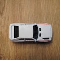 Top view of a white Audi Quattro Mattel Hot Wheels toy car on a wooden surface Royalty Free Stock Photo