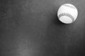 Top view of white baseball ball isolated on a dark rough surface Royalty Free Stock Photo