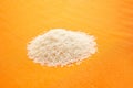 Top view of white basmati rice on an orange background