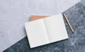 Top view of white binder blank notebook or diary or journal for writing text and message with pencil on concrete background with Royalty Free Stock Photo