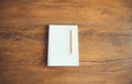 Top view of white blank notebook with pencil pen on wooden table Royalty Free Stock Photo