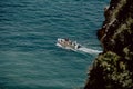 Top view of a white boat sailing in the ocean