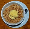 Top view of white bowl on table filled with tasty oats prepared by chef with vanilla ice cream on top, gread dessert ideas that Royalty Free Stock Photo