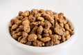 Top view of white bowl with tiger nuts, white blank background, selective focus,