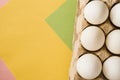 Top view of white chicken eggs in an open egg carton on colorful background. Copy space. Natural healthy food and organic farming Royalty Free Stock Photo