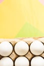 Top view of white chicken eggs in an open egg carton on colorful background. Copy space. Natural healthy food and organic farming Royalty Free Stock Photo