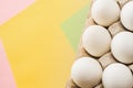 Top view of white chicken eggs in an open egg carton on colorful background. Copy space. Natural healthy food and Royalty Free Stock Photo