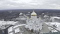 Top view of white church with golden domes in winter. Clip. Beautiful landscape of church on mountain on background of Royalty Free Stock Photo