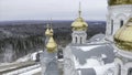 Top view of white church with golden domes in winter. Clip. Beautiful landscape of church on mountain on background of Royalty Free Stock Photo