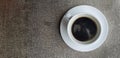 Top view of white cup of black coffee on grunge background or table with copy space on right. Royalty Free Stock Photo