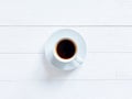 Top view of white cup of black coffee or hot chocolate on a shabby white board wooden table. Flat lay lifestyle, copy space. Royalty Free Stock Photo