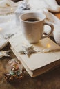 Coffee, book, silver Christmas gift and decorations on a wooden background Royalty Free Stock Photo