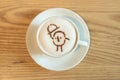 Top view a white cup of coffee with cartoon latte art made from cocoa powder Royalty Free Stock Photo