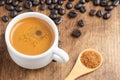 Top view of white cup with coffee on wooden table with coffee beans and wooden spoon with brown sugar, Royalty Free Stock Photo
