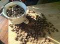 top view with white cup filled with freshly roasted coffee beans isolated on wood plank Royalty Free Stock Photo