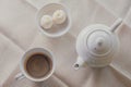 white cup of hot coffee and pot served with two small mooncake on table with vintage tone. Break times concept Royalty Free Stock Photo