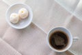 White cup of hot coffee served with two small mooncake on table with vintage tone. Break times concept Royalty Free Stock Photo