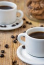 Top view of white cups of coffee, on rustic wooden table with coffee beans and jar with cookies, selective focus, Royalty Free Stock Photo