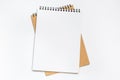 Top view of white desk with blank notebook in the middle. Royalty Free Stock Photo