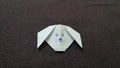 Top view of White dog origami drwan with face