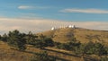Top view of white domed buildings of observatories on hill. Shot. Astronomical research facilities and large