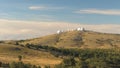 Top view of white domed buildings of observatories on hill. Shot. Astronomical research facilities and large
