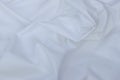 Top view of sharp White colored fabric, wrinkles